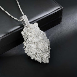 Silver floral pendant necklace on a dark surface