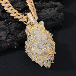Gold lion pendant necklace on a dark background