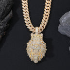Gold chain necklace with a detailed pendant on a black background