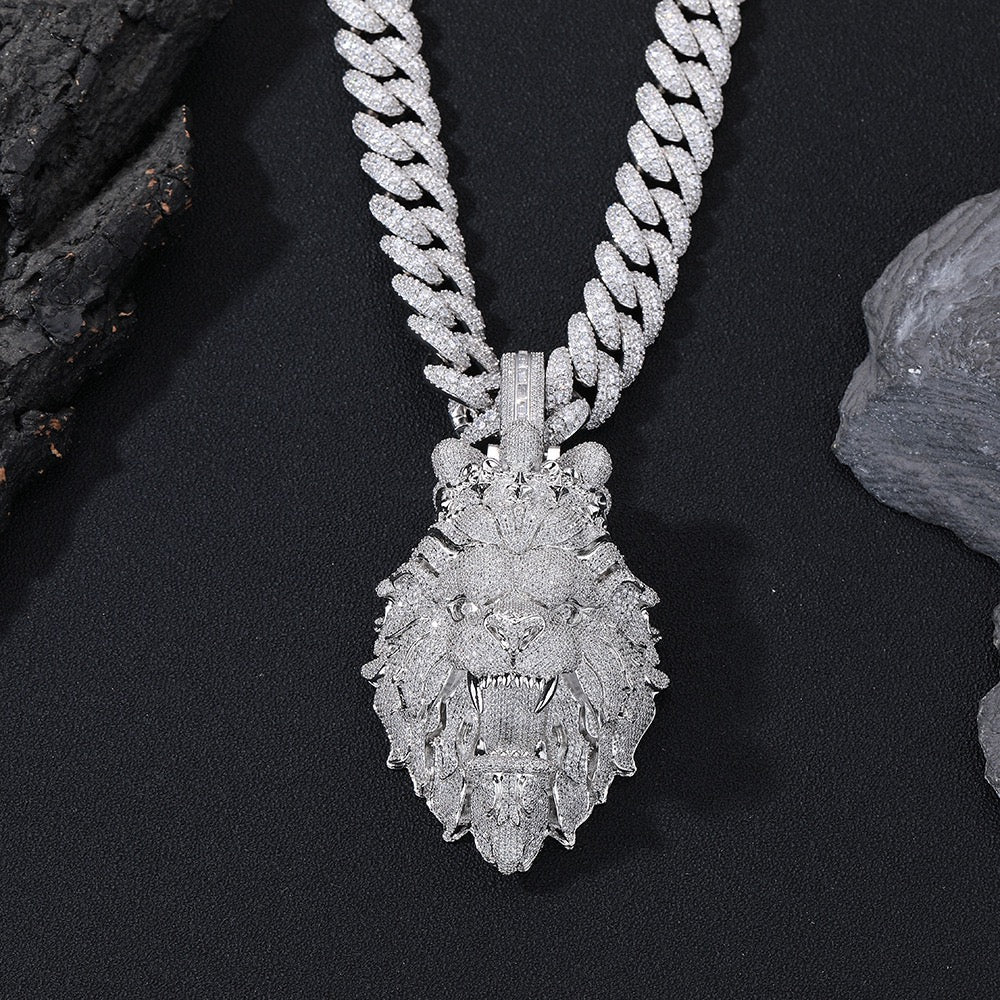 Silver necklace with a detailed pendant on a dark surface