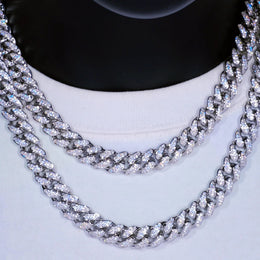 Close-up of two iced out Cuban link chains on a white shirt, hip hop jewelry - Miles Jewellery