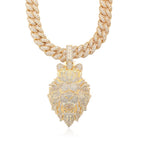 Gold necklace with a lion head pendant on a white background