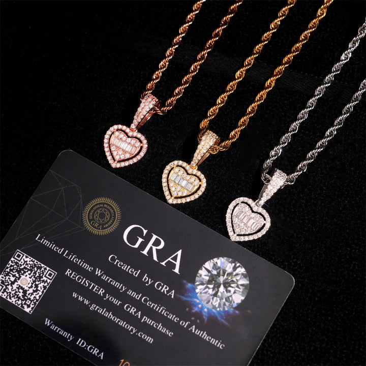 Pink-tone, gold-tone and silver-tone heart necklaces beside GRA cards