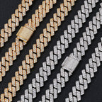 Gold and silver iced out Cuban link chains with diamond clasps on black background - Miles Jewellery
