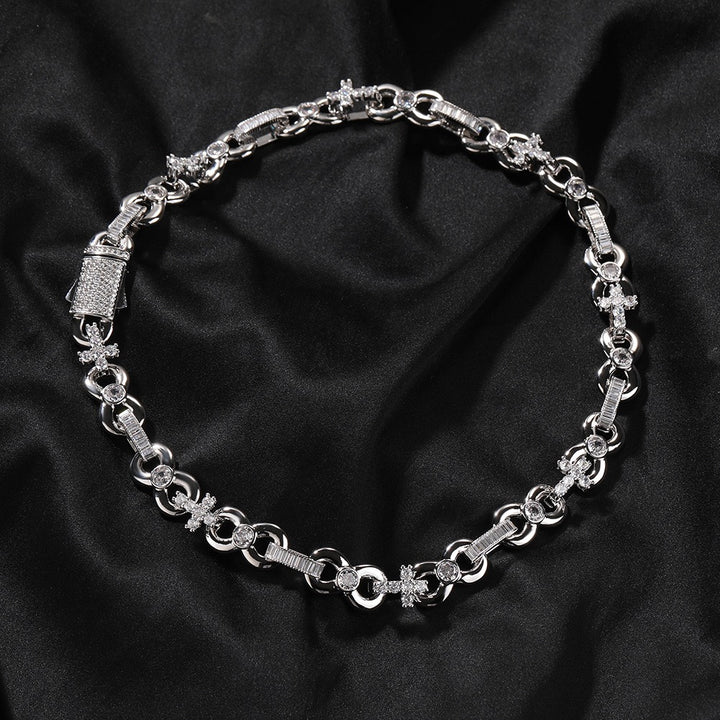 Silver-tone necklace with alternating oval and round links arranged on black fabric