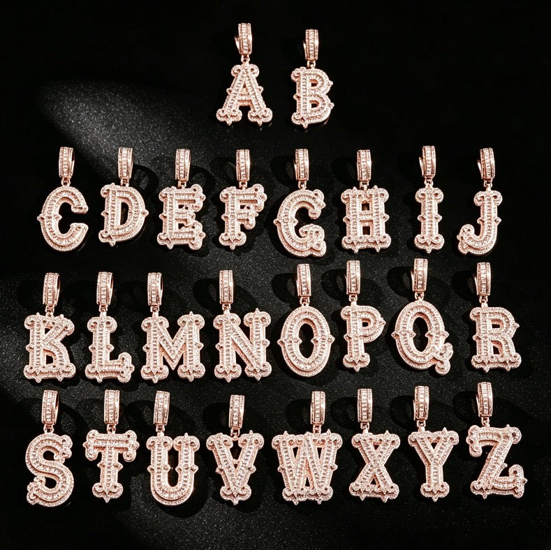 Pink-tone stone-set alphabet pendants arranged from A to Z