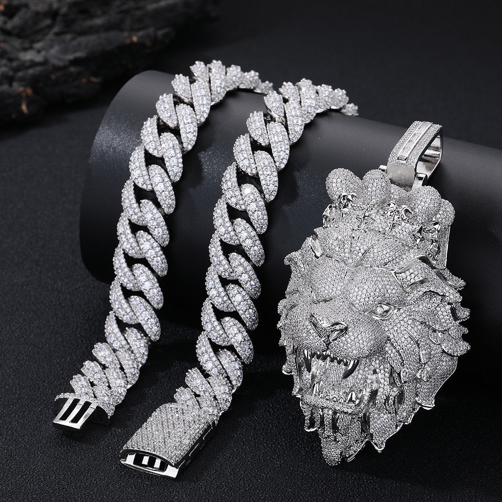 Silver chain bracelet and lion head pendant on a black background