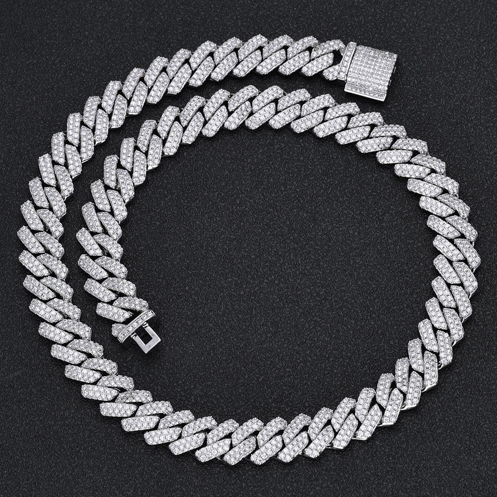 Iced out Cuban link chain with pave stones on black background - Miles Jewellery