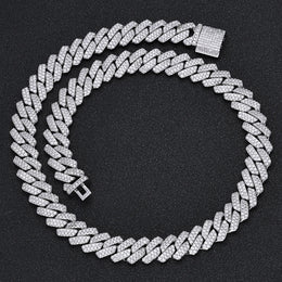 Iced out Cuban link chain with pave stones on black background - Miles Jewellery