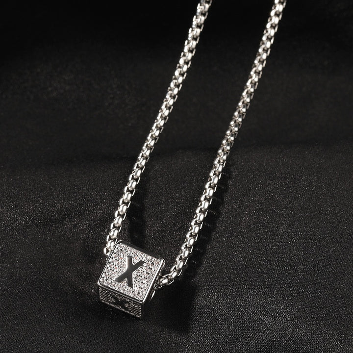 Silver-tone letter Y block pendant on a Cuban link chain against black fabric