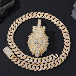 Gold chain necklace with a lion pendant on a black background