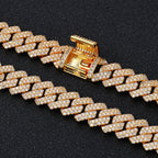 Gold Cuban link chain with iced out diamonds on black background - Miles Jewellery