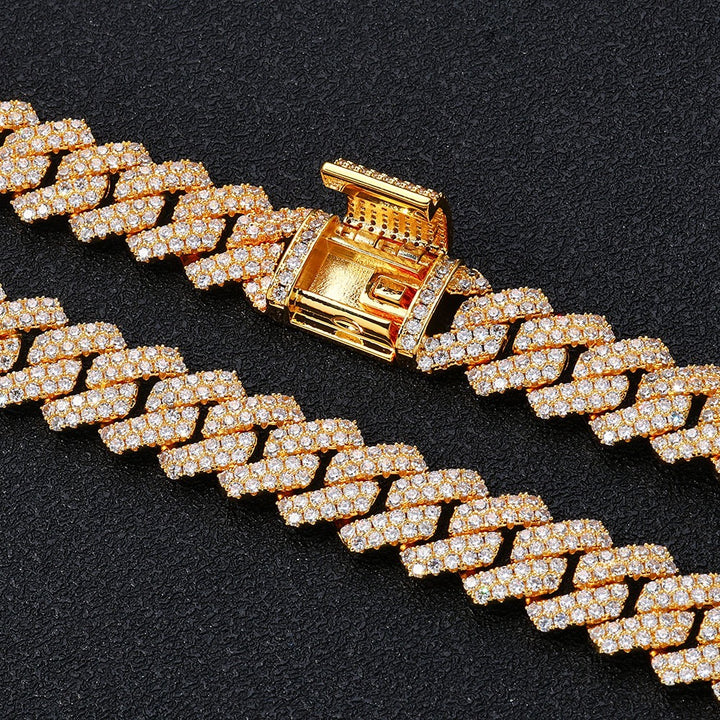 Close-up of the open box clasp on a gold-tone stone-set Cuban link chain
