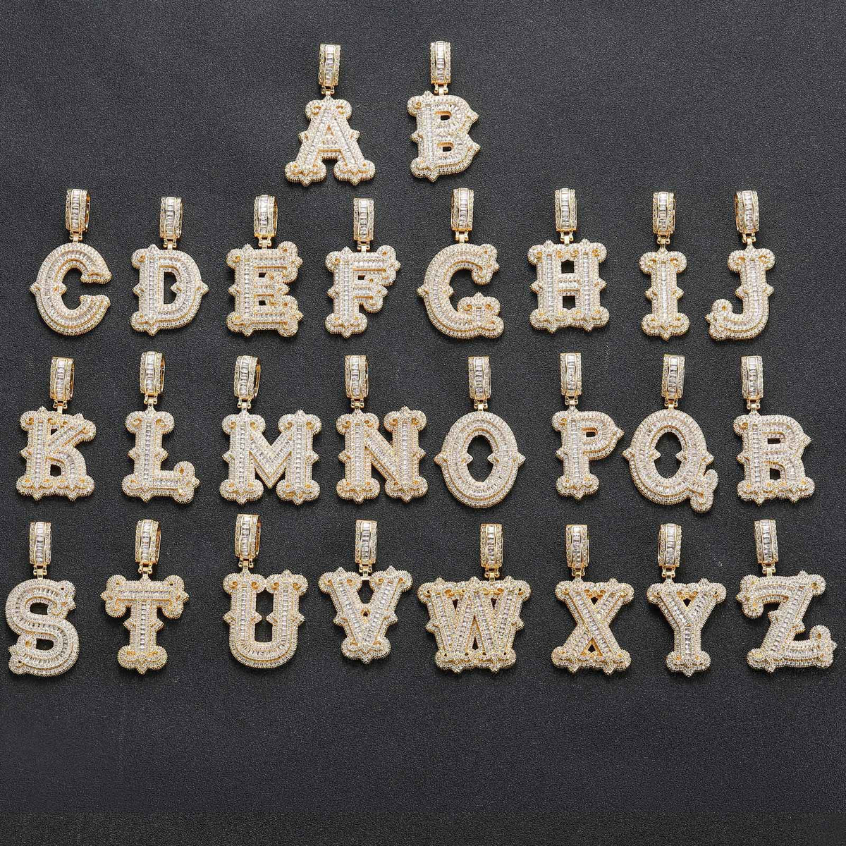 Gold-tone stone-set alphabet pendants arranged from A to Z