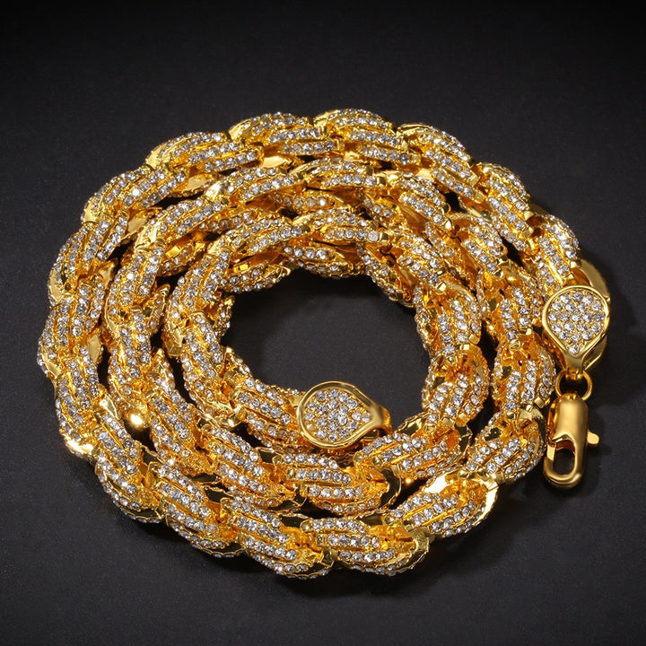 Gold-tone stone-set twisted rope chain coiled on black
