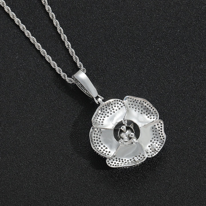 Back of a silver-tone rose pendant showing the petal structure and openings