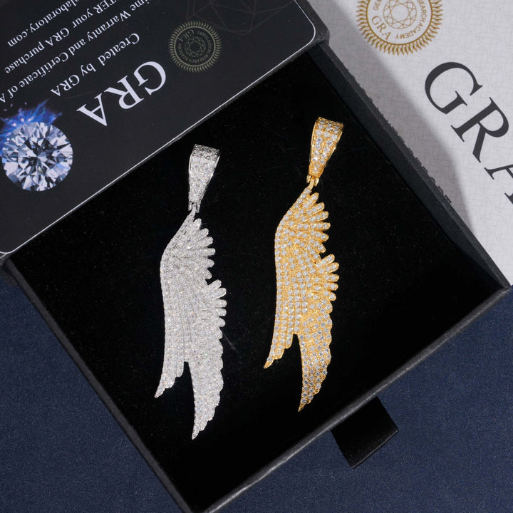 Silver-tone and gold-tone angel wing pendants in a black box