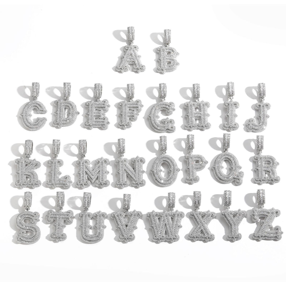 Silver-tone stone-set alphabet pendants arranged in rows on white