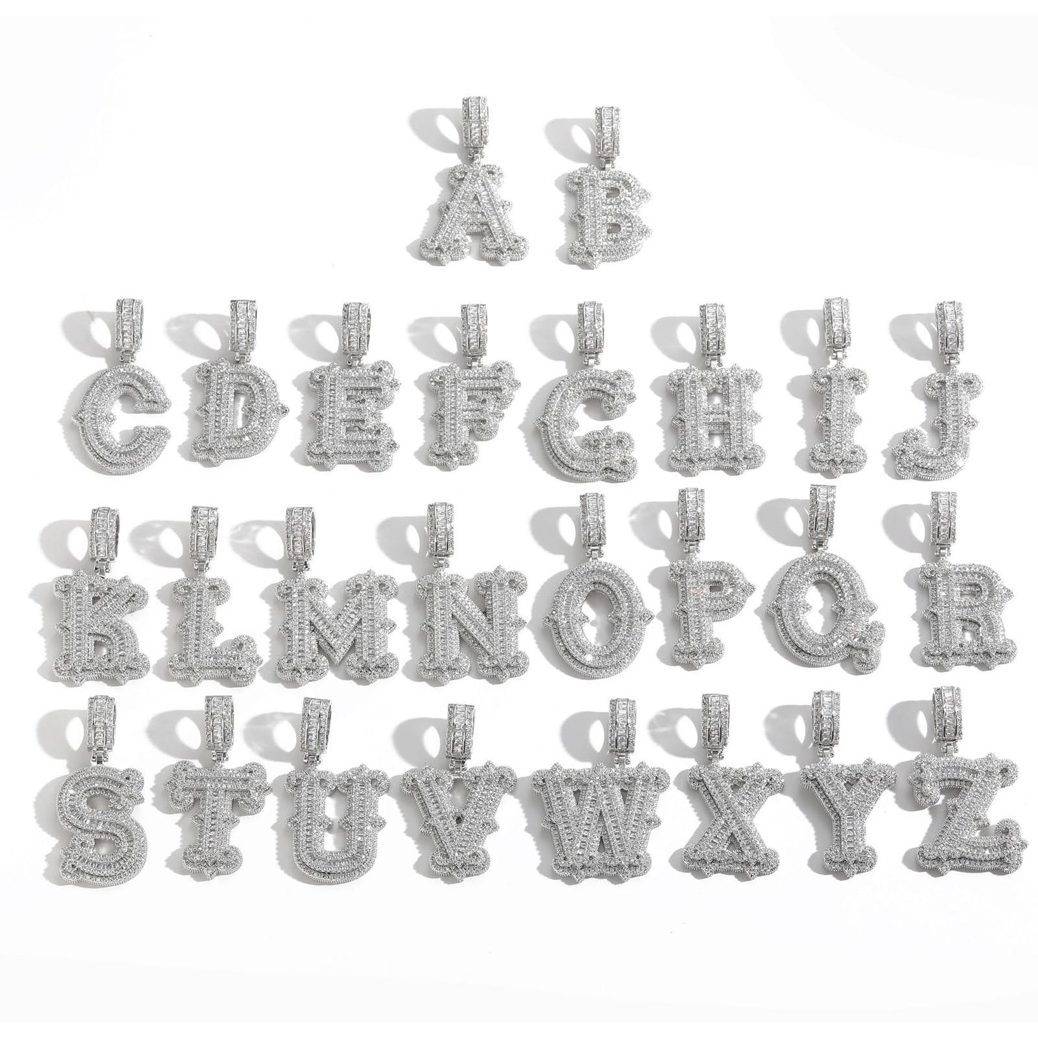 Silver-tone stone-set alphabet pendants arranged in rows on white