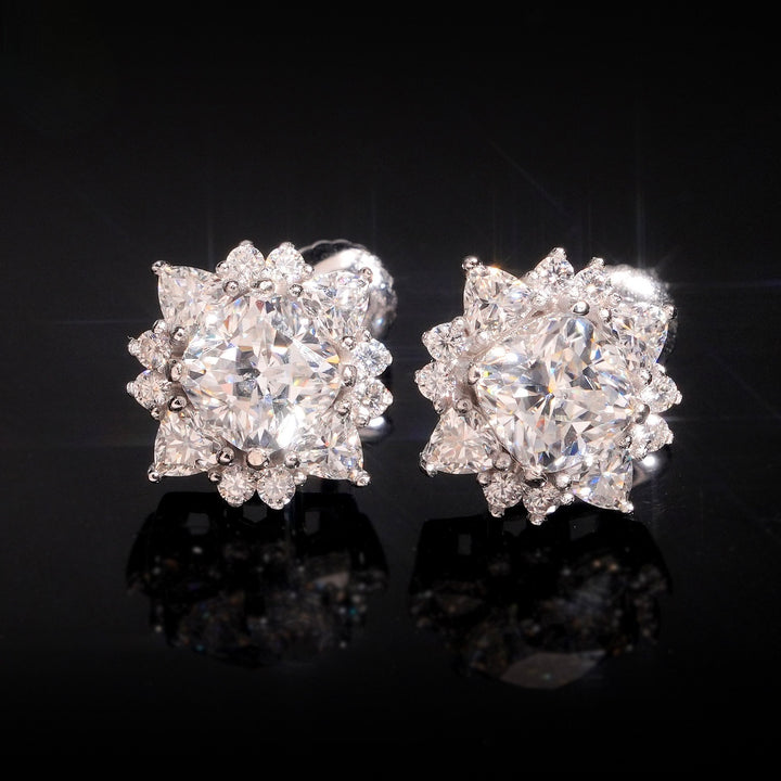 Silver-tone sunburst stud earrings on a dark surface