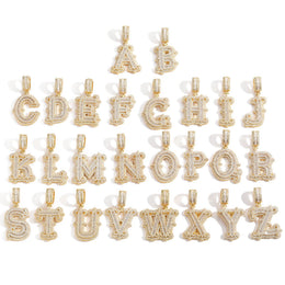 Gold-tone stone-set alphabet pendants arranged in rows on white
