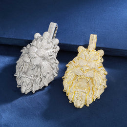 Gold and silver lion head pendants on a blue background