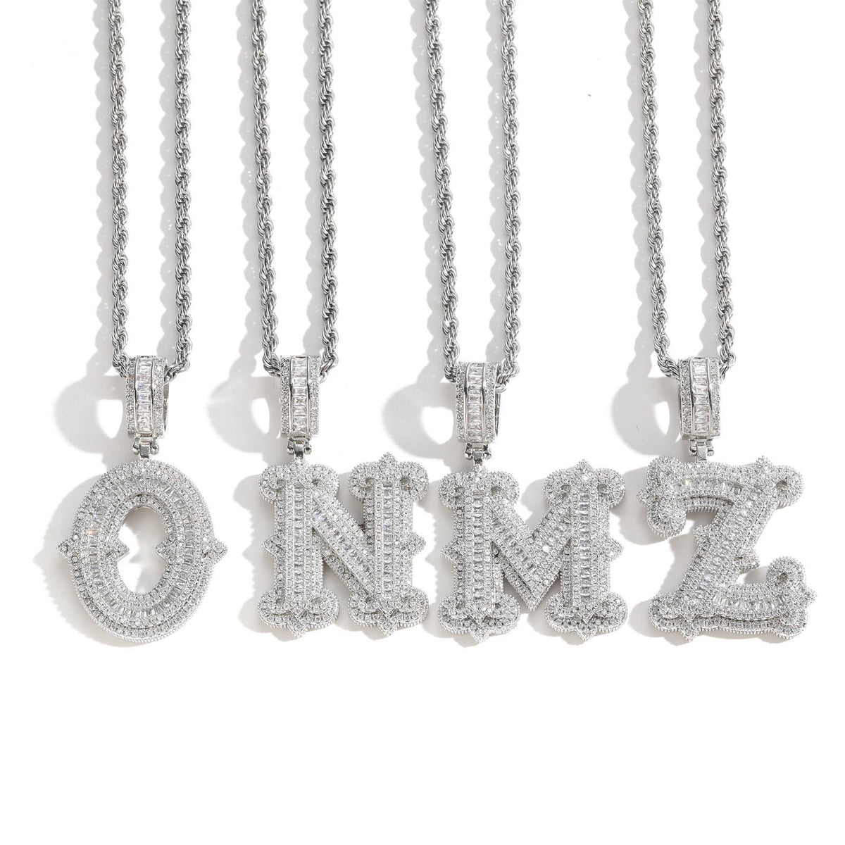 Silver-tone stone-set letter pendants hanging from chains