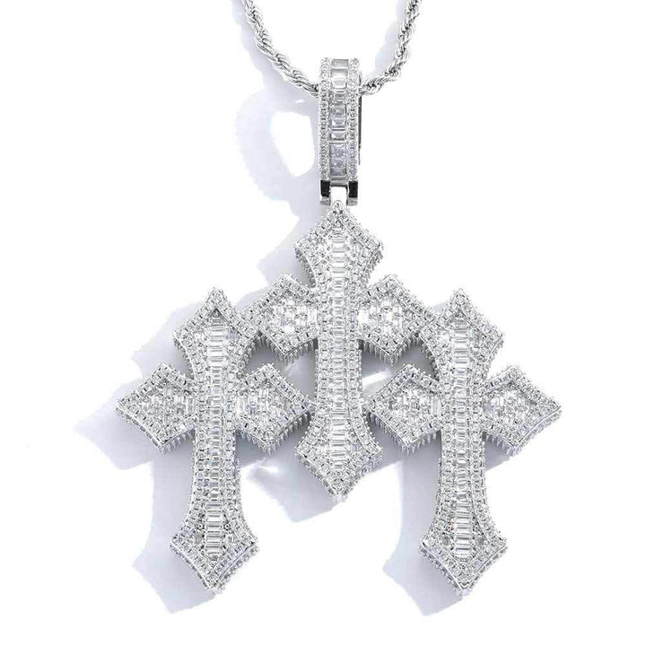 Silver-tone stone-set triple cross pendant on a chain against white