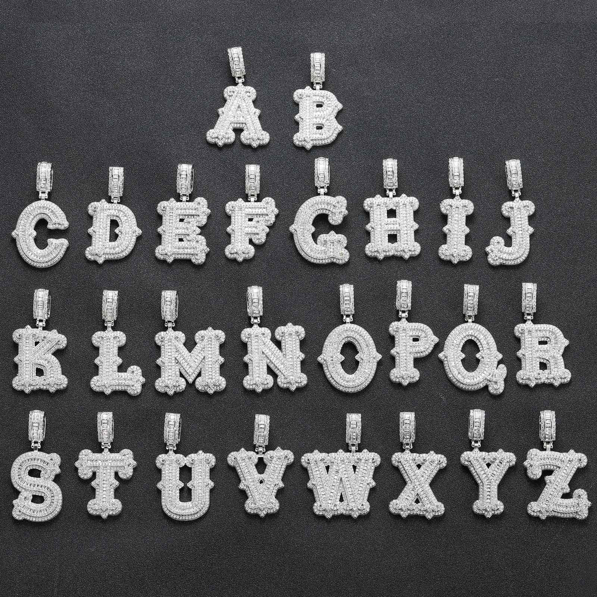 Silver-tone stone-set alphabet pendants arranged from A to Z