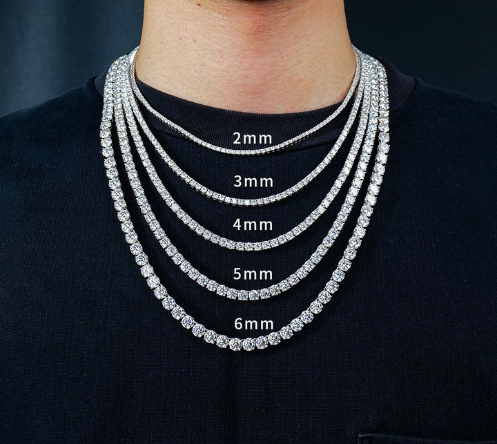 Tennis necklaces worn together with widths labelled 2mm, 3mm, 4mm, 5mm and 6mm