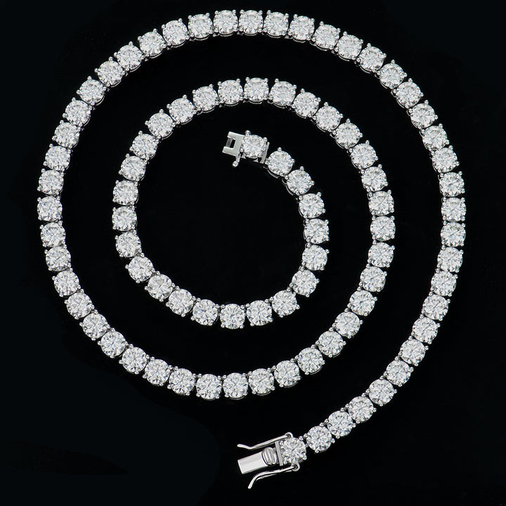 Silver-tone tennis necklace coiled against a black background