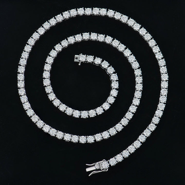 Silver-tone tennis necklace coiled against a black background