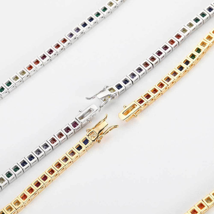 Backs of gold-tone and silver-tone multicolored tennis chains showing settings and clasps