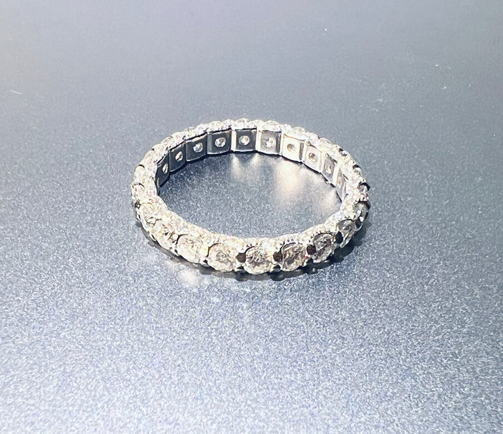 Slim silver-tone eternity ring with round clear stones