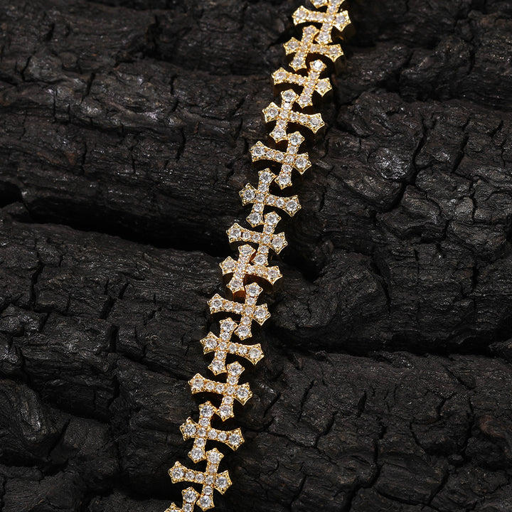 Gold-tone cross-link chain on a dark textured surface