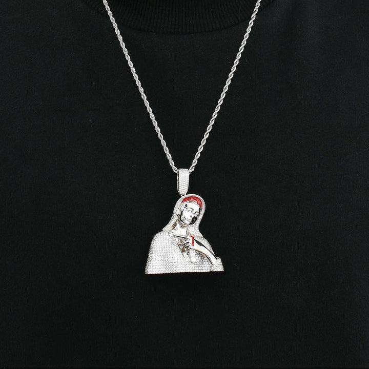 Silver-tone hooded portrait pendant worn on a fine chain against black