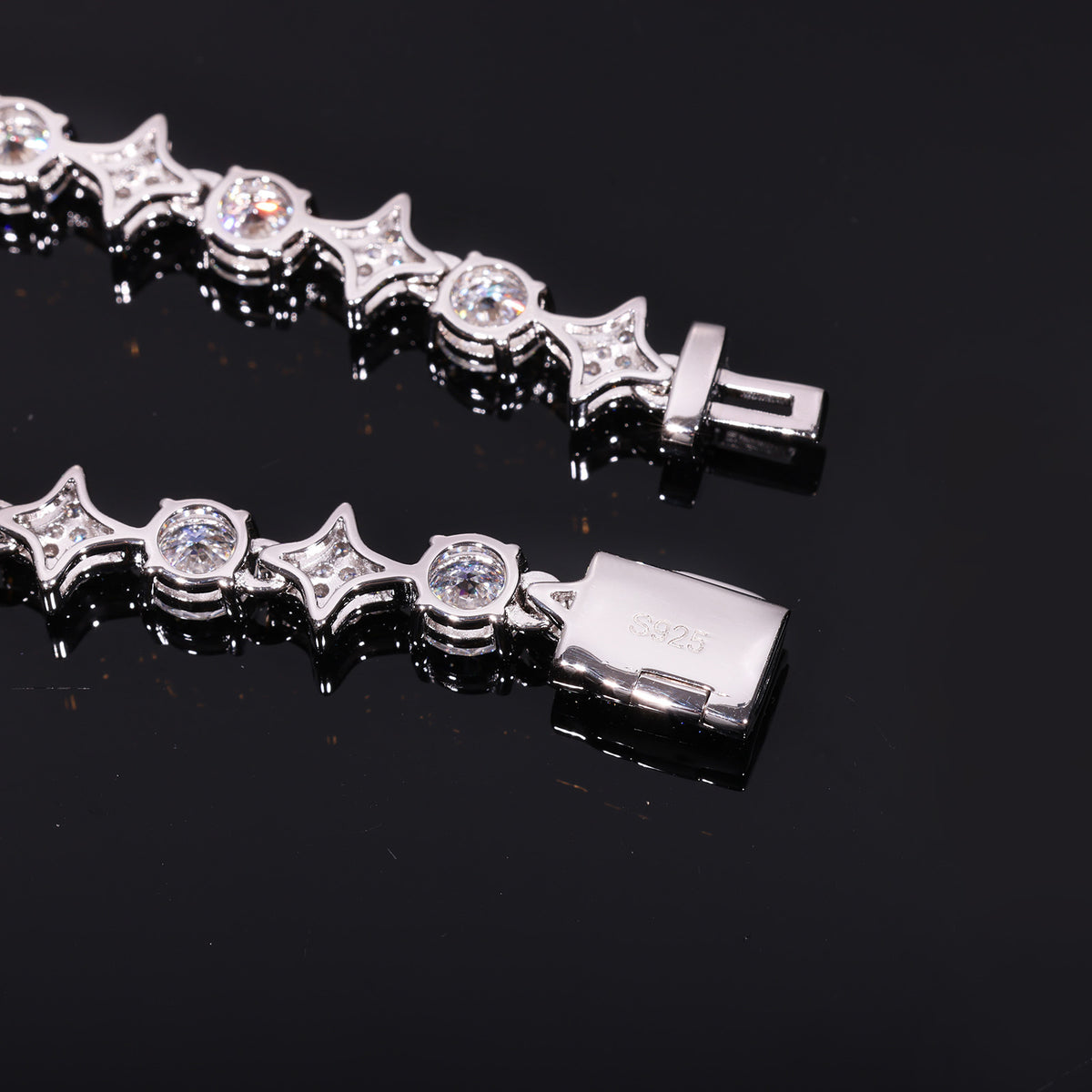Polished backs of star and round links with an open box clasp marked S925