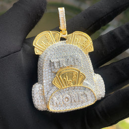 Two-tone backpack pendant with gold-tone banknote details and a silver-tone body