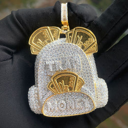 Front view of the two-tone backpack pendant held on a black glove