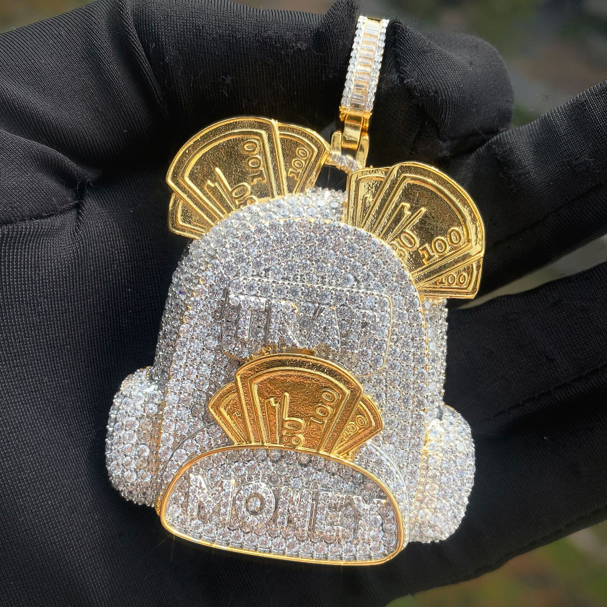 Two-tone backpack pendant with a pavé body and raised money motifs