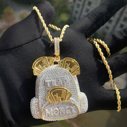 Two-tone backpack pendant displayed on a black glove outdoors