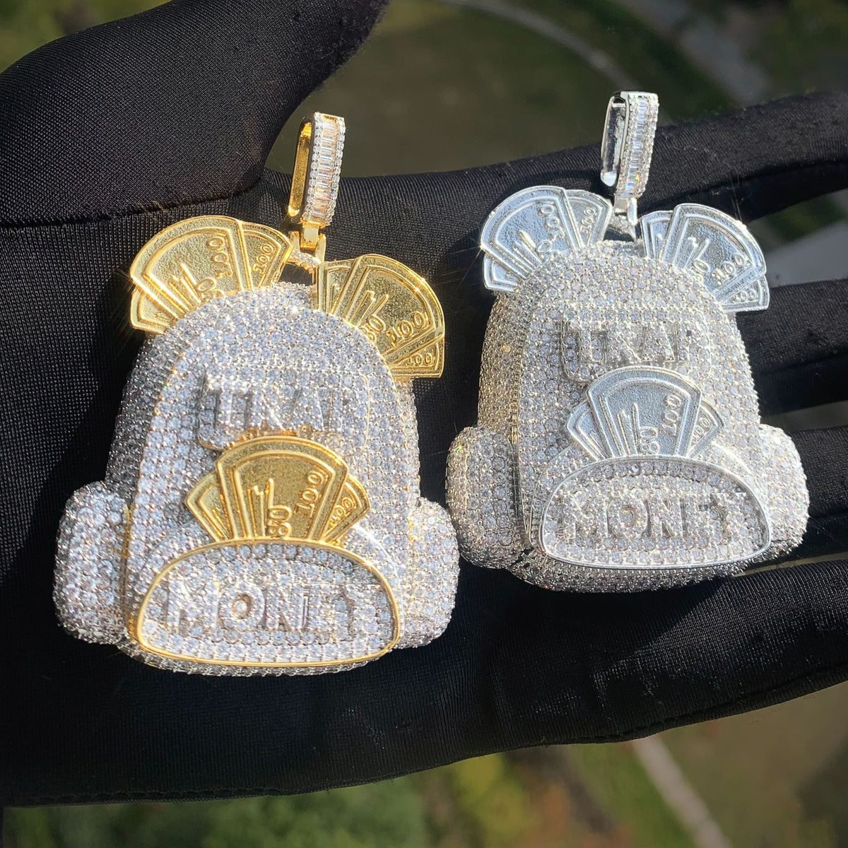 Silver-tone and two-tone backpack pendants displayed side by side