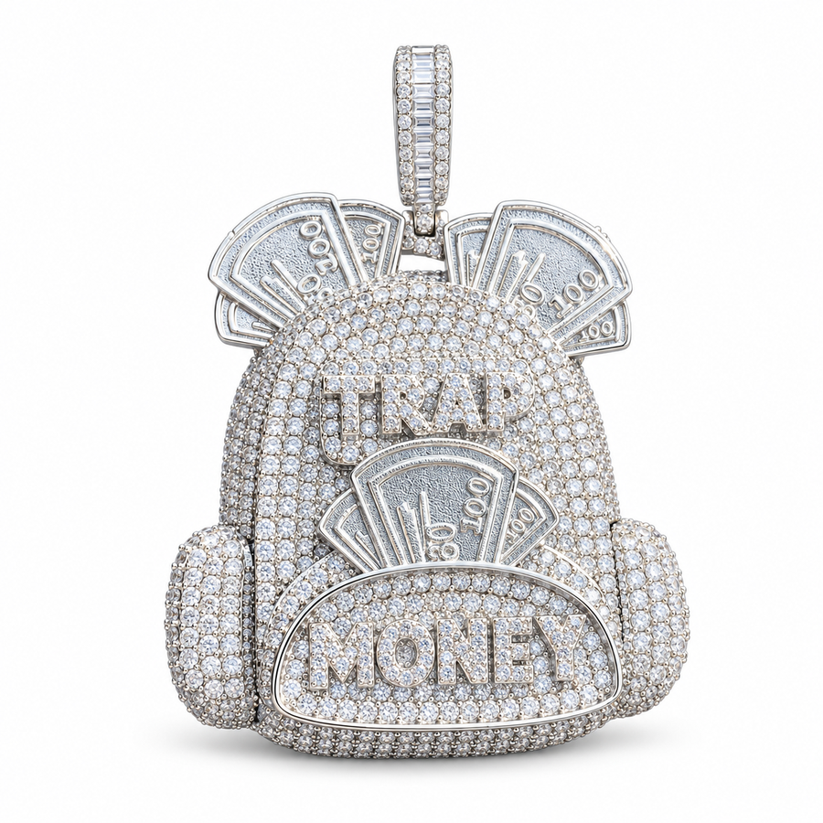 Silver-tone backpack pendant with a pavé body, raised pocket and banknote motifs on white