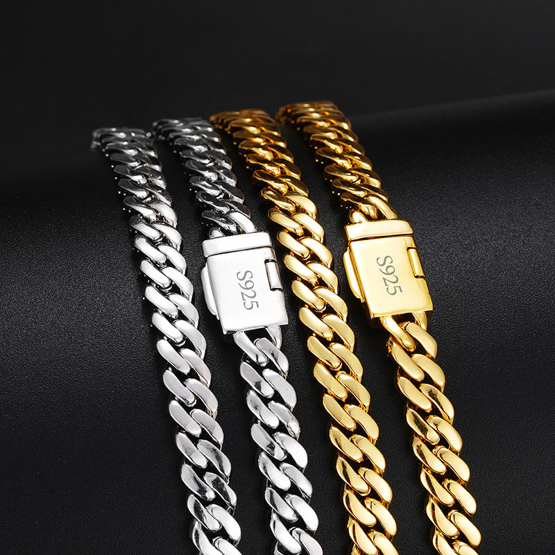 Polished backs of silver-tone and gold-tone Cuban links with S925 marks on the clasps