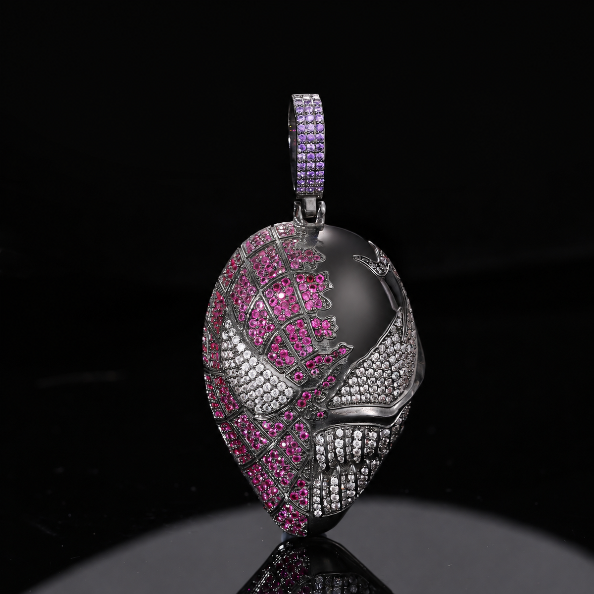 Dark silver-tone fanged mask pendant with pink and clear stones and a purple stone-set bail