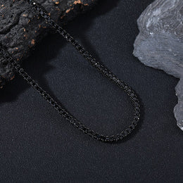 Dark-background detail view of 4mm iced black CZ tennis chain necklace