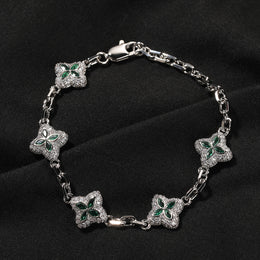 Silver-tone four-leaf clover bracelet link and stone detail
