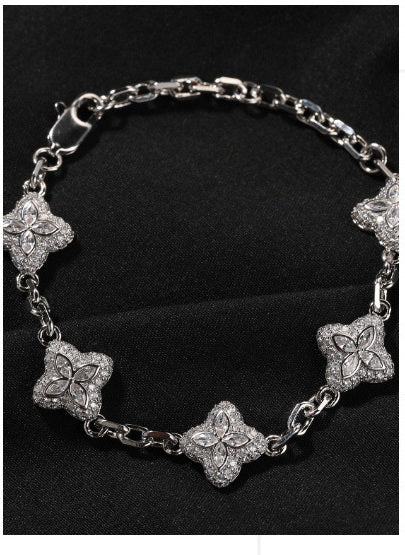 Silver-tone four-leaf clover bracelet link and stone detail