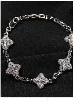Silver-tone four-leaf clover bracelet link and stone detail