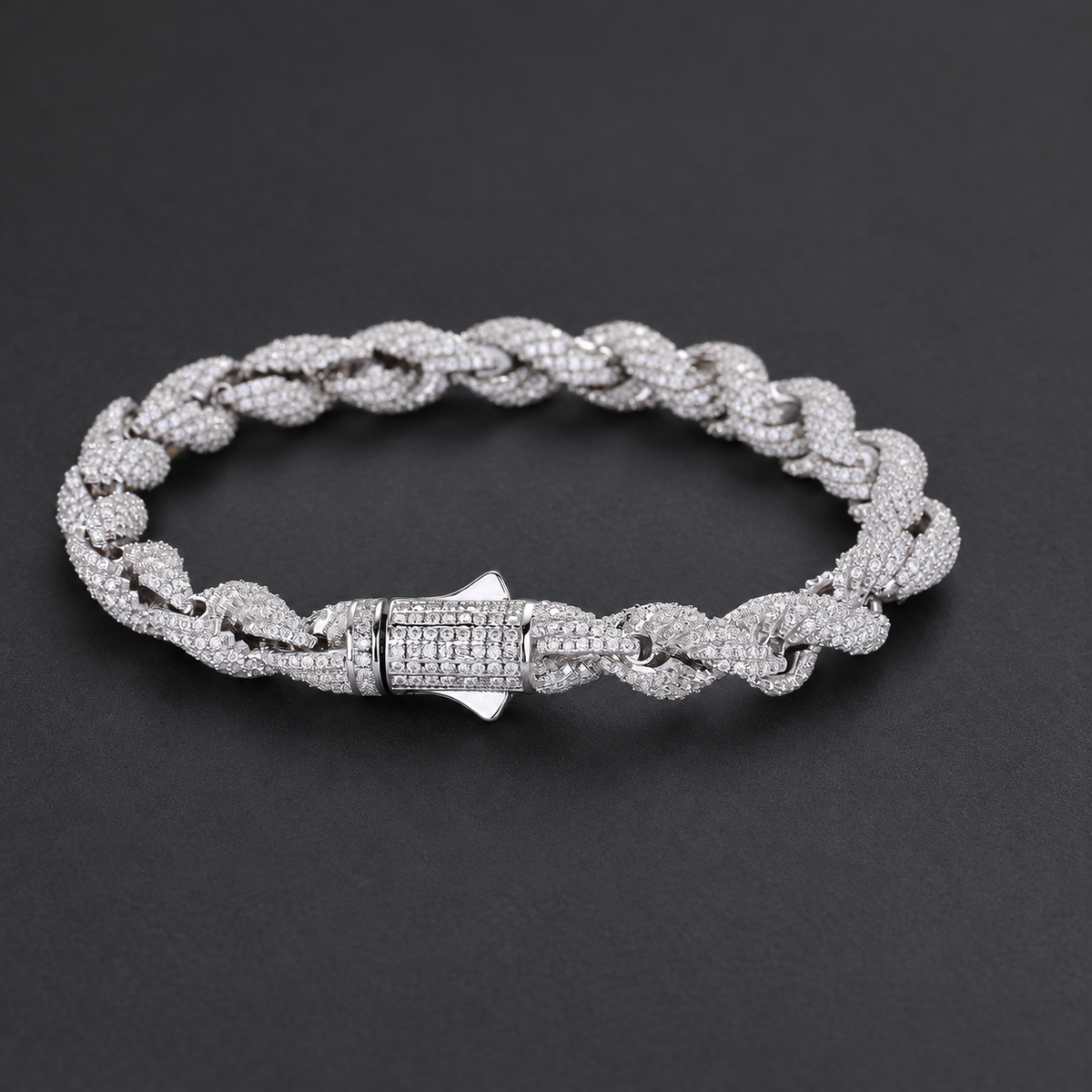 Rope bracelet on a dark surface, showing the front of its box clasp